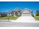 Charming single-story home with well-maintained landscaping, gray stucco, stone accents and a two-car garage at 5531 Pebble Beach Dr, Lakeland, FL 33812