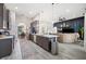 Open concept kitchen featuring a large island with quartz countertops, stainless steel appliances, and modern cabinets at 5531 Pebble Beach Dr, Lakeland, FL 33812