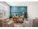 Bright office space featuring a rustic wooden desk with storage, patterned chairs, and stylish decor at 5531 Pebble Beach Dr, Lakeland, FL 33812