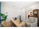 Bright office space featuring a rustic wooden desk with storage, patterned chairs, and view into dining area at 5531 Pebble Beach Dr, Lakeland, FL 33812