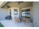 Covered patio space with a glass table and chairs, grill, and ceiling fan at 5531 Pebble Beach Dr, Lakeland, FL 33812