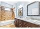 Well-lit bathroom showcasing a walk-in shower and a dual sink vanity with granite countertops at 6347 Ashley Dr, Lakeland, FL 33813