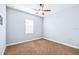 A cozy bedroom features a ceiling fan, neutral walls, and plush carpeting at 6347 Ashley Dr, Lakeland, FL 33813