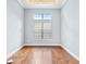 Bright bedroom with hardwood floors, natural light from the window, and neutral wall color at 6347 Ashley Dr, Lakeland, FL 33813