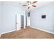 A bright bedroom offers a ceiling fan, closet, and neutral decor at 6347 Ashley Dr, Lakeland, FL 33813