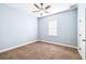 Inviting bedroom with neutral walls, ceiling fan, and cozy carpet flooring at 6347 Ashley Dr, Lakeland, FL 33813