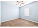 Cozy bedroom with a ceiling fan, carpet, and a window providing natural light at 6347 Ashley Dr, Lakeland, FL 33813