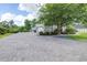 Spacious driveway leading to the garage, surrounded by mature trees and manicured landscaping at 6347 Ashley Dr, Lakeland, FL 33813