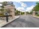 Beautiful entryway features detailed stonework, secure access control, and lush landscaping at 6347 Ashley Dr, Lakeland, FL 33813