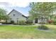 Landscaped front yard featuring lush lawn, stone walkway, and mature trees creating an inviting curb appeal at 6347 Ashley Dr, Lakeland, FL 33813