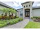 Charming home exterior with lush landscaping, stone walkway, and a welcoming front entrance with double doors at 6347 Ashley Dr, Lakeland, FL 33813