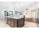 Open-concept kitchen with stainless steel appliances, granite countertops, and a view to the spacious living area at 6347 Ashley Dr, Lakeland, FL 33813
