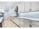 Gourmet kitchen with white cabinets, granite countertops, stainless steel appliances, and tile backsplash at 6347 Ashley Dr, Lakeland, FL 33813