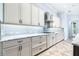 Stylish kitchen features white cabinets, granite countertops, stainless steel appliances, and tile backsplash at 6347 Ashley Dr, Lakeland, FL 33813