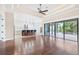 Open-concept living room with access to the outdoor patio, featuring a pool, and a modern kitchen at 6347 Ashley Dr, Lakeland, FL 33813