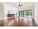 Open-concept living room with wood floors, recessed lighting, and seamless transition to the outdoor patio with a pool at 6347 Ashley Dr, Lakeland, FL 33813