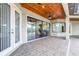 Wonderful covered patio area with wood ceiling and views through floor-to-ceiling sliding glass doors at 6347 Ashley Dr, Lakeland, FL 33813