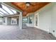 Charming covered patio featuring a ceiling fan, wood ceiling, and views of the pool area at 6347 Ashley Dr, Lakeland, FL 33813