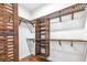 Organized walk-in closet with custom shelving and wooden accents, perfect for storage at 6347 Ashley Dr, Lakeland, FL 33813