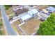 Aerial view of property featuring the home, white fence backyard, mature trees, and surrounding neighborhood at 640 Waldon N Ave, Bartow, FL 33830