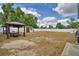 Large backyard featuring a shed, privacy fence, and a gazebo with table and chairs at 640 Waldon N Ave, Bartow, FL 33830