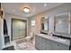 Bathroom featuring a dual sink vanity and glass-enclosed shower at 640 Waldon N Ave, Bartow, FL 33830
