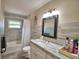 Neutral bathroom with a shower-tub combination and modern vanity at 640 Waldon N Ave, Bartow, FL 33830