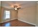 Bedroom featuring hardwood floors, neutral walls, ceiling fan, and window at 640 Waldon N Ave, Bartow, FL 33830