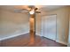Bedroom with hardwood floors, neutral walls, ceiling fan, and large closet at 640 Waldon N Ave, Bartow, FL 33830
