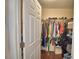 Walk-in closet filled with clothing hanging on rods and stacked on shelves at 640 Waldon N Ave, Bartow, FL 33830