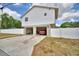 Exterior elevation with the garage below the main living space and a white fence at 640 Waldon N Ave, Bartow, FL 33830