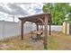 Gazebo featuring a table and chairs and overhead lighting, next to a fenced yard at 640 Waldon N Ave, Bartow, FL 33830