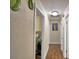 Hallway featuring tile floors with access to multiple rooms, laundry, and a painting on the wall at 640 Waldon N Ave, Bartow, FL 33830