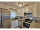 This kitchen features stainless steel appliances, white cabinets, and granite counters at 640 Waldon N Ave, Bartow, FL 33830