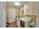 Bright laundry room features a washer, dryer, and storage cabinets at 640 Waldon N Ave, Bartow, FL 33830