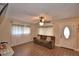 Comfortable living room featuring a brown couch, tile floors, and a ceiling fan with ornate lighting at 640 Waldon N Ave, Bartow, FL 33830