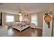 Main bedroom with a colorful bed, hardwood flooring, and bright natural light at 640 Waldon N Ave, Bartow, FL 33830