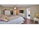 Bright main bedroom with wood floors, ceiling fan, and ensuite bathroom at 640 Waldon N Ave, Bartow, FL 33830
