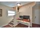 A staircase landing has a computer desk, with wood floors and a staircase with a window at 640 Waldon N Ave, Bartow, FL 33830