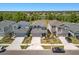 Aerial view of upscale homes in a well-planned community, with a serene lake and lush landscaping at 6520 Great Bear Dr, Lakeland, FL 33805