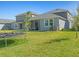 Expansive backyard with green grass, partial trampoline, and screened porch at 6520 Great Bear Dr, Lakeland, FL 33805