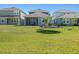Spacious backyard featuring lush green grass and a screened patio at 6520 Great Bear Dr, Lakeland, FL 33805