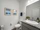 Bathroom featuring a white vanity with granite countertop, oval sink, and decorative framed art at 6520 Great Bear Dr, Lakeland, FL 33805