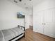 Clean bedroom with sleek furnishings, tv, wood-look floors, and modern aesthetic at 6520 Great Bear Dr, Lakeland, FL 33805