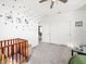 Bedroom bedroom with carpet, ceiling fan, crib, and dot-patterned decor at 6520 Great Bear Dr, Lakeland, FL 33805