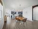 Open concept living space with modern dining table and a view to the kitchen at 6520 Great Bear Dr, Lakeland, FL 33805