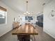 Open concept living space with modern dining table and a view to the kitchen at 6520 Great Bear Dr, Lakeland, FL 33805
