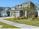Two-story home boasting a gray exterior, attached garage, and well-maintained landscaping at 6520 Great Bear Dr, Lakeland, FL 33805
