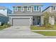 Charming two-story home featuring a two-car garage, well-maintained lawn, and inviting front door at 6520 Great Bear Dr, Lakeland, FL 33805