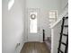 Foyer with white front door, decorative wreath, and access to stairs at 6520 Great Bear Dr, Lakeland, FL 33805